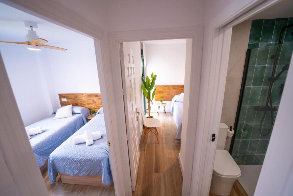 a small room with a bed and a couch at Apartasuites Royal Zahara, Máximo confort con vistas al mar in Zahara de los Atunes