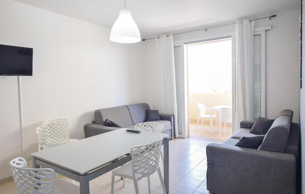 sala de estar con sofá, mesa y sillas en Nice Apartment In Marina Di Ragusa With Kitchenette, en Marina di Ragusa