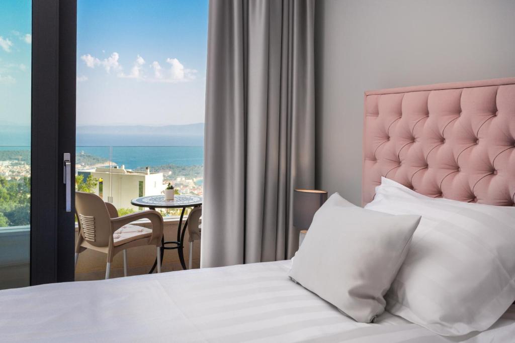 a bedroom with a bed and a view of the ocean at Villa Harmony in Makarska