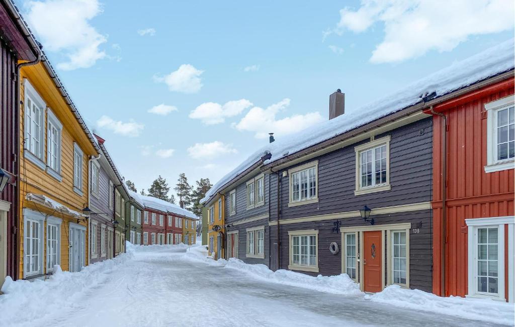 a snow covered street in a town with buildings at Nice Apartment In Bjorli With Wifi in Bjorli