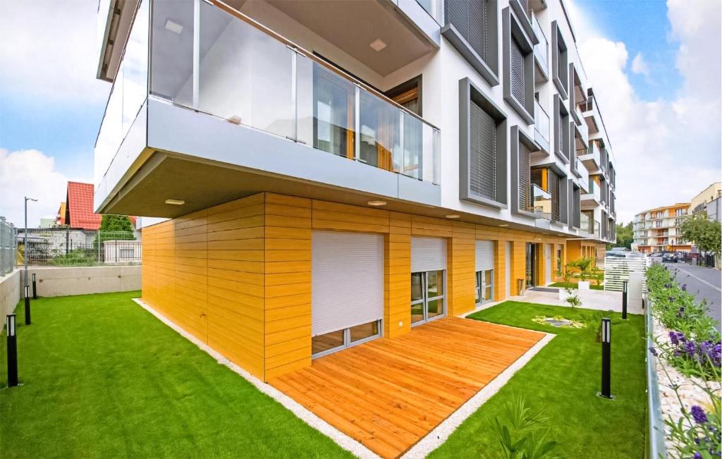 um grande edifício com um pátio verde em frente em Lovely Apartment In Hel With Kitchen em Hel