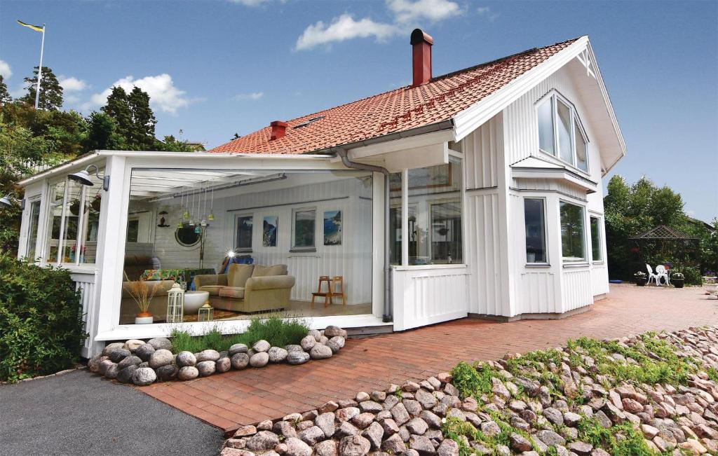 a white house with a large open patio at Nice Home In Alingss With Lake View in Alingsås