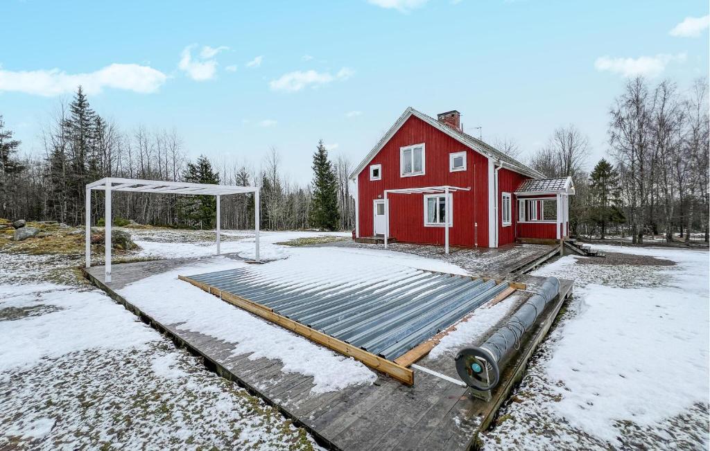 a red house with a soccer goal in front of it at Cozy Home In Nrkesberg With Outdoor Swimming Pool in Närkesberg