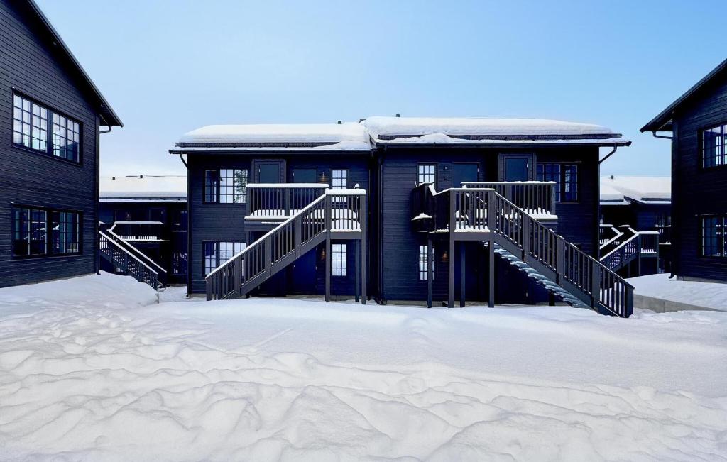 a building with snow on the ground in front of it at Awesome Apartment In Idre With House A Panoramic View in Idre