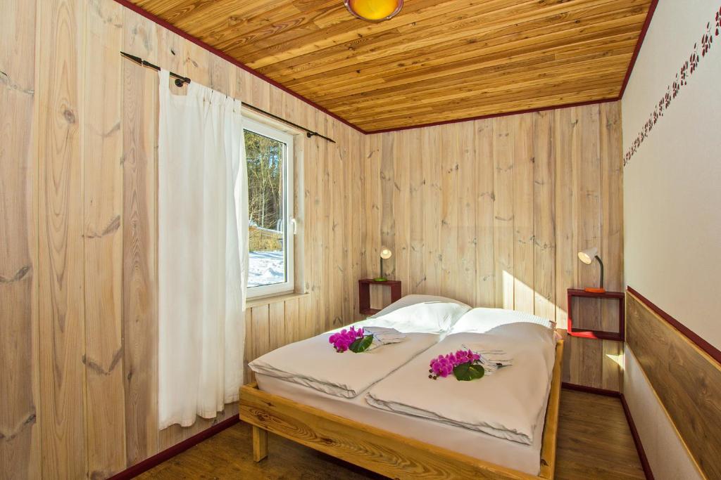 ユッケリッツにあるHerzmuschelのベッドルーム1室(花の飾られたベッド1台付)