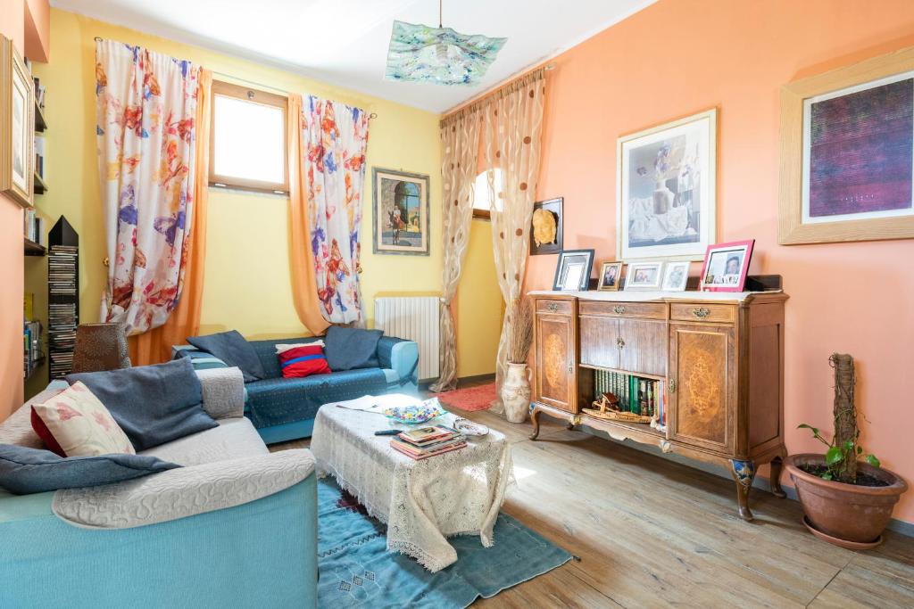 sala de estar con sofá azul y chimenea en Piccolo e intimo centro città, en Nuoro