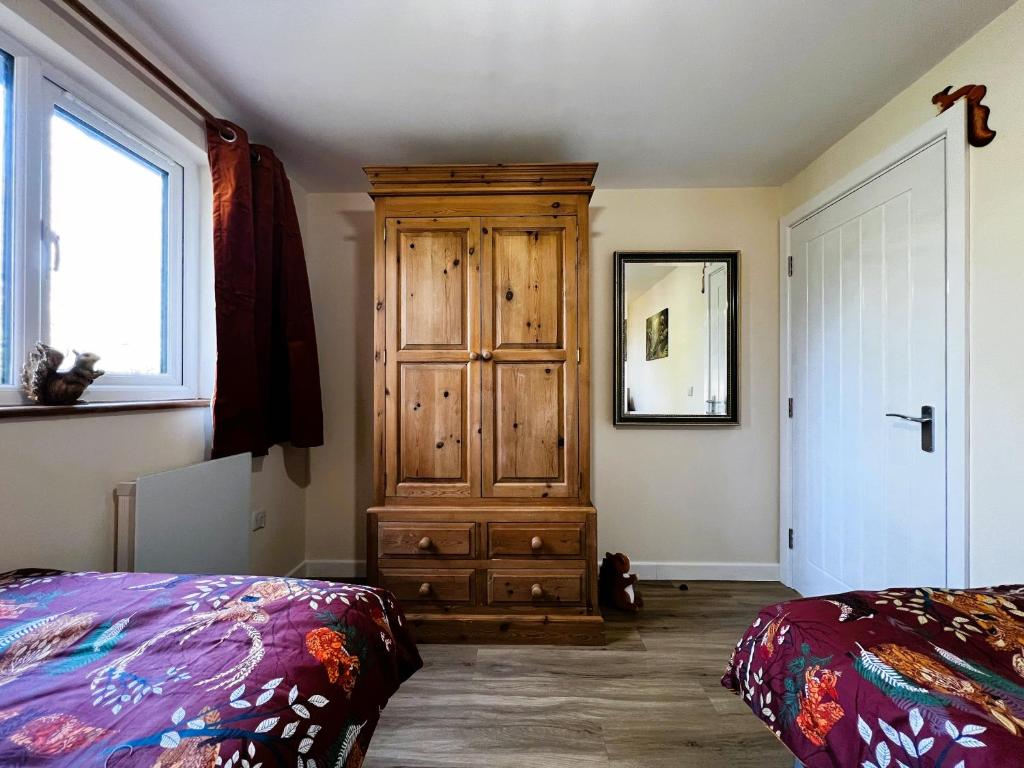 Postel nebo postele na pokoji v ubytování Cherry Lodge