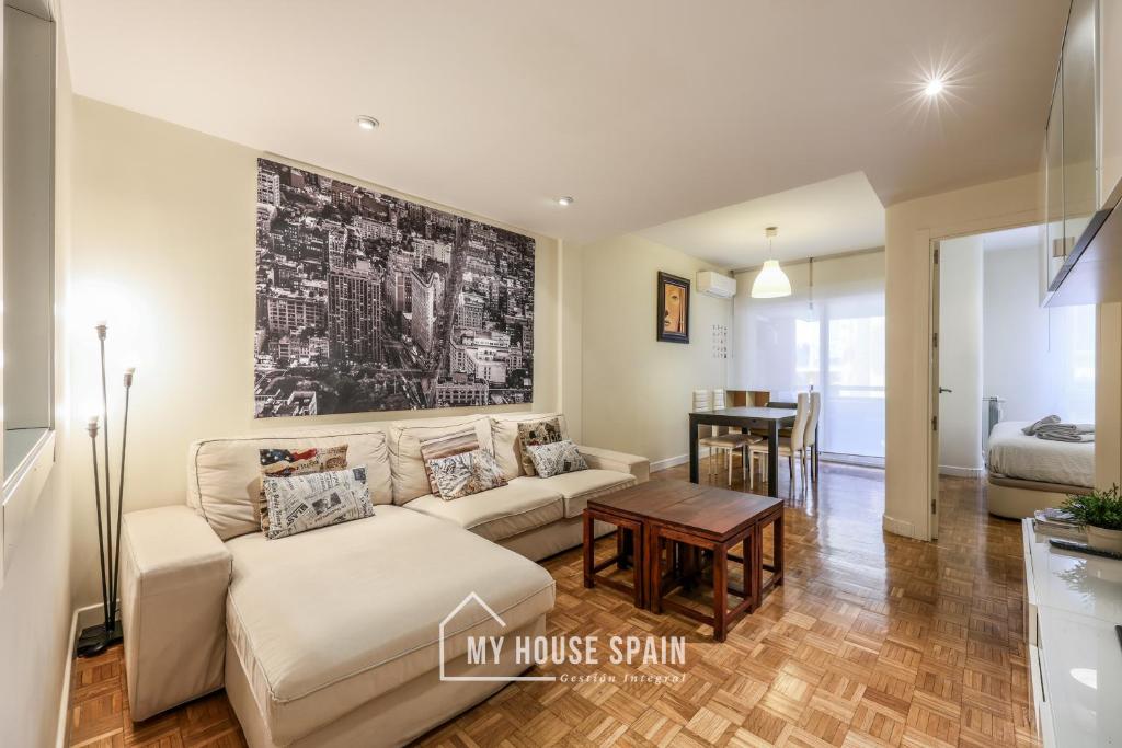 a living room with a couch and a table at MyHouseSpain-Tranquilo apartamento con balcón in Madrid