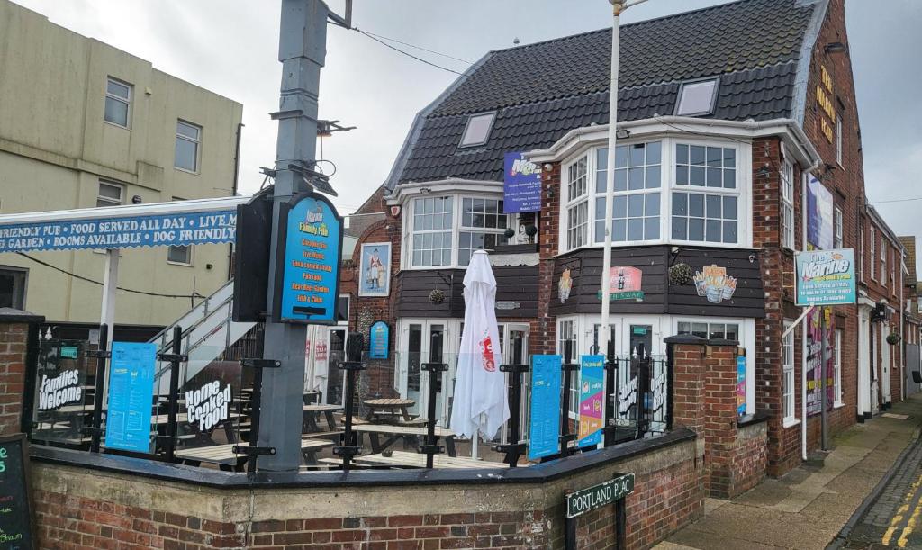 a brick building with an umbrella on a street at Marine hotel in Great Yarmouth