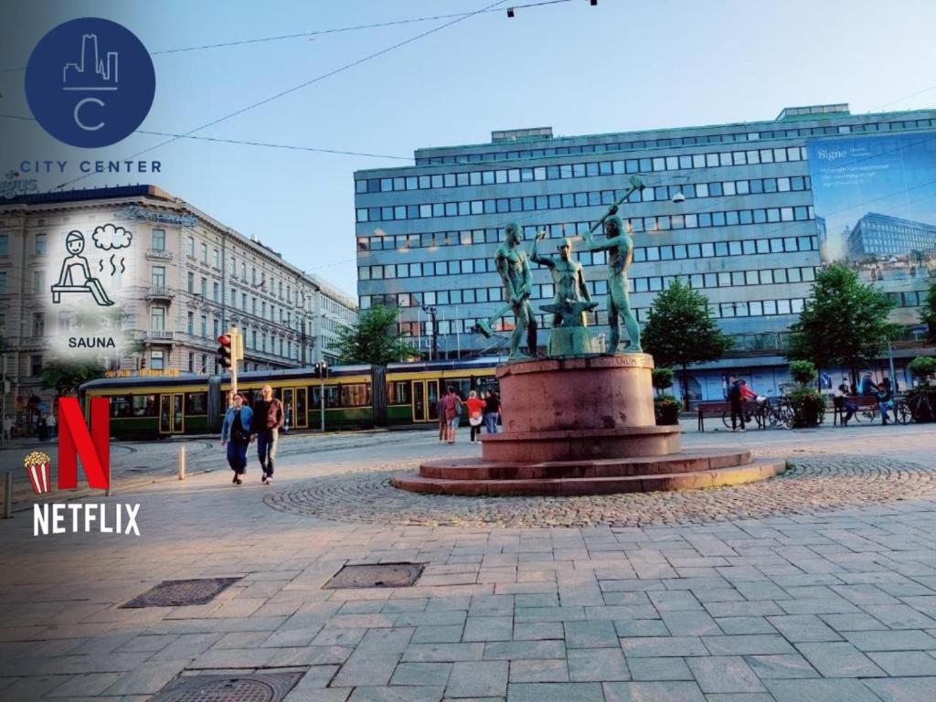 a statue in the middle of a plaza with buildings at TwoSteps from Helsinki Railway Stationシ in Helsinki