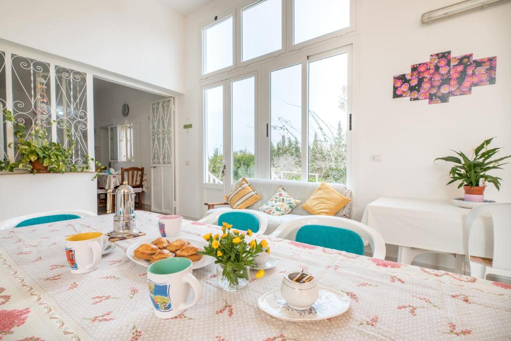 a dining room with a table with food on it at La Dimora Lucia by Paf in tour in Torre Suda