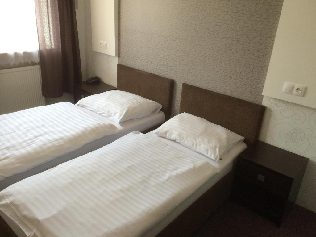 Ένα ή περισσότερα κρεβάτια σε δωμάτιο στο Promohotel Slavie