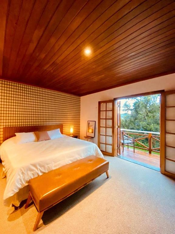 Uma cama ou camas num quarto em Tília Pousada de Charme