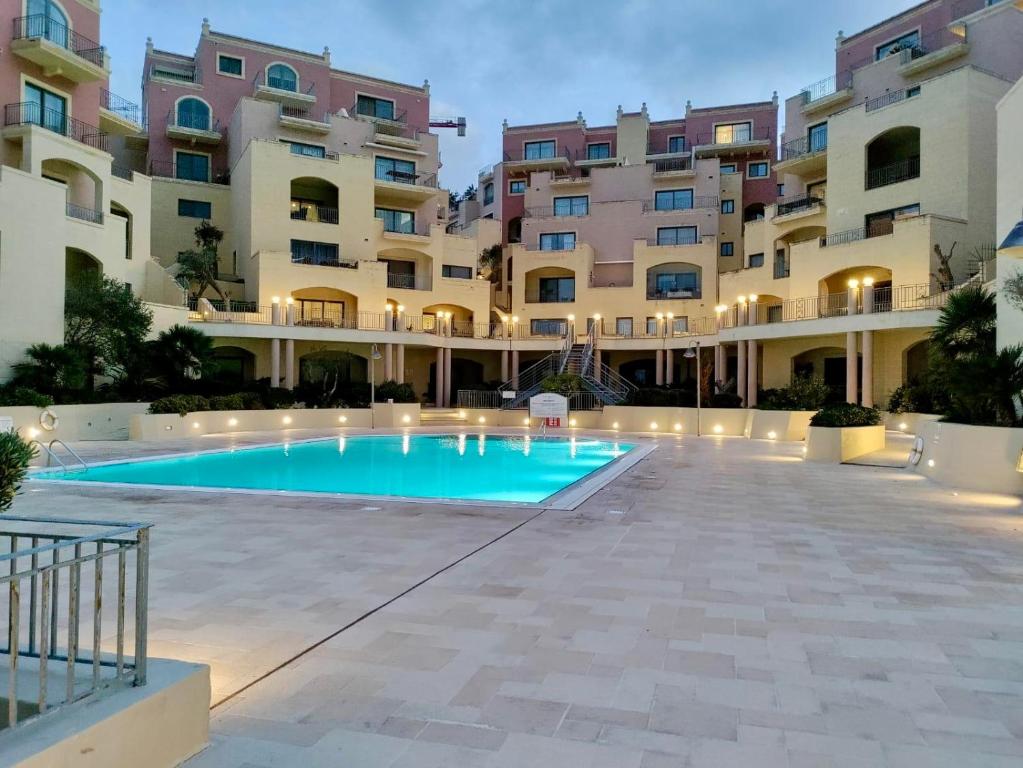 una piscina di fronte a un edificio di Spacious Luxurious Apartment with Seaview a Mellieħa