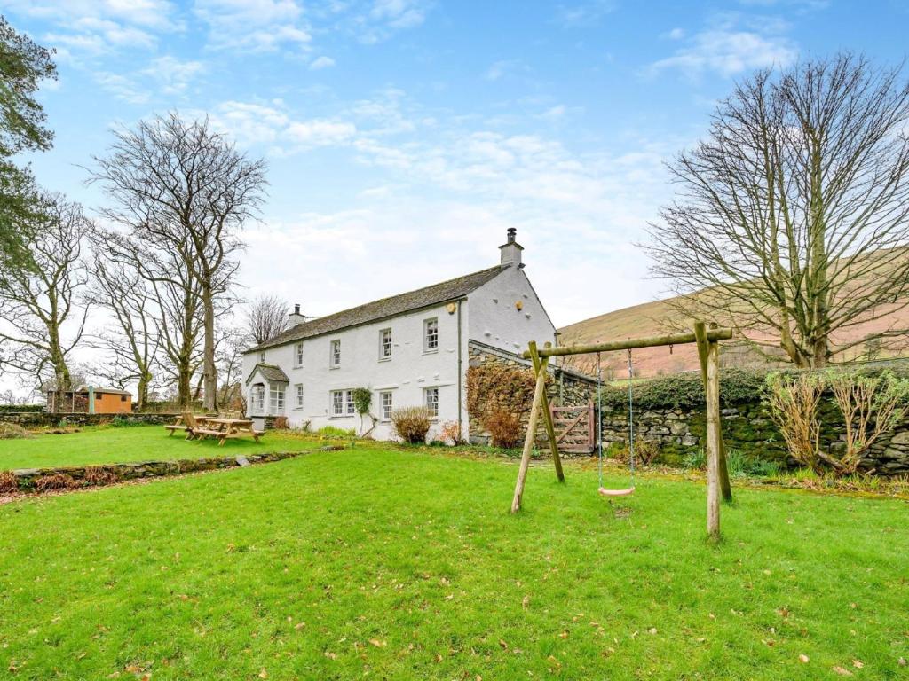 a large white house with a grass yard at 5 Bed in Threlkeld SZ270 in Threlkeld