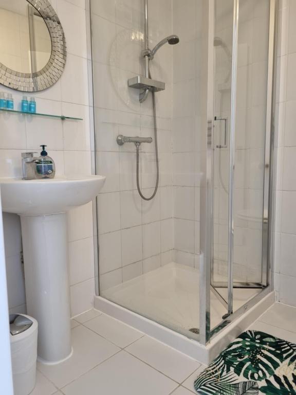 a bathroom with a shower and a sink at The Windmill Hotel in London