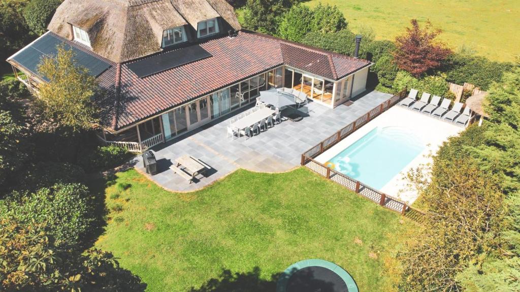 an overhead view of a house with a swimming pool at Beautiful American style villa with heated Pool and Jacuzzi in Heerhugowaard