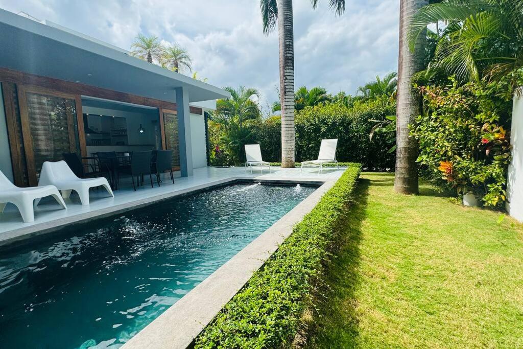 a swimming pool in the backyard of a house at Private Garden Villa in Las Terrenas
