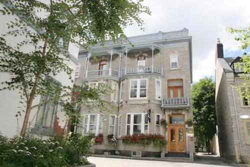 a large apartment building on a city street at Hotel Ermitage in Quebec City