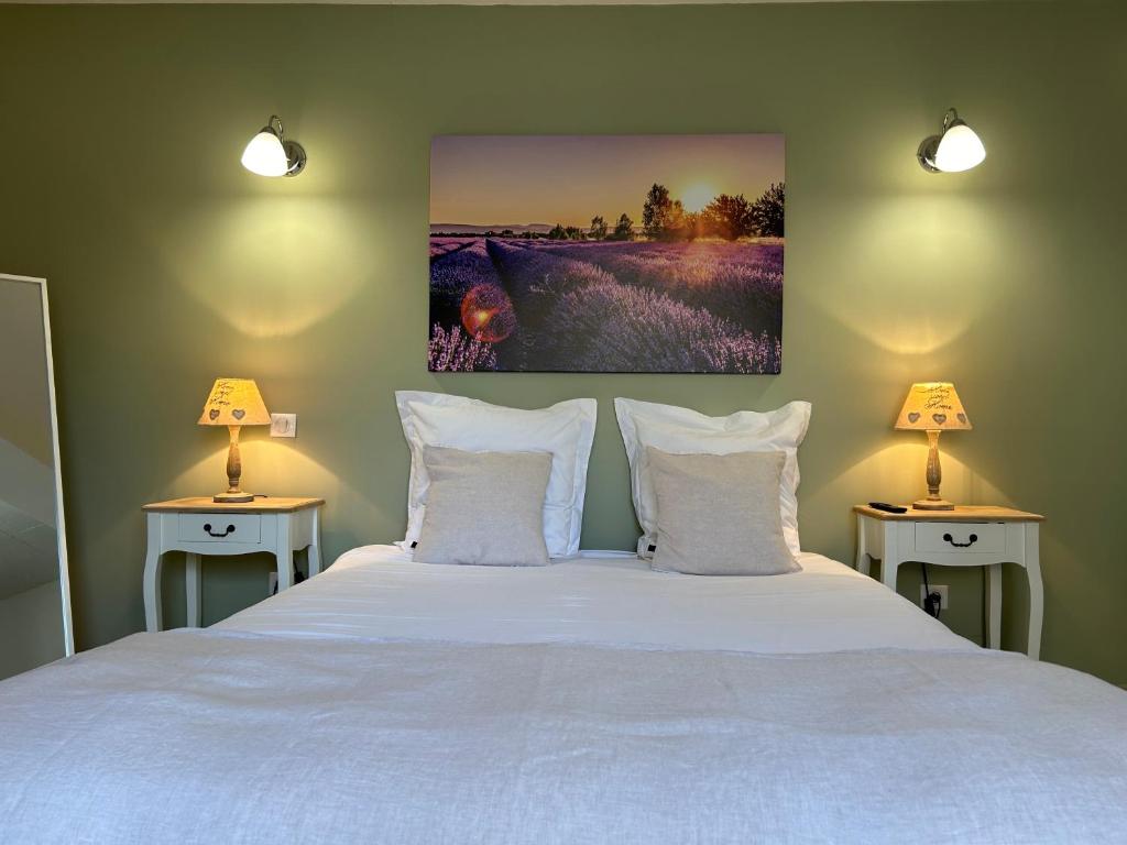 a bedroom with a large white bed with two lamps at Détours en Provence - Lavande 3* in Châteaurenard