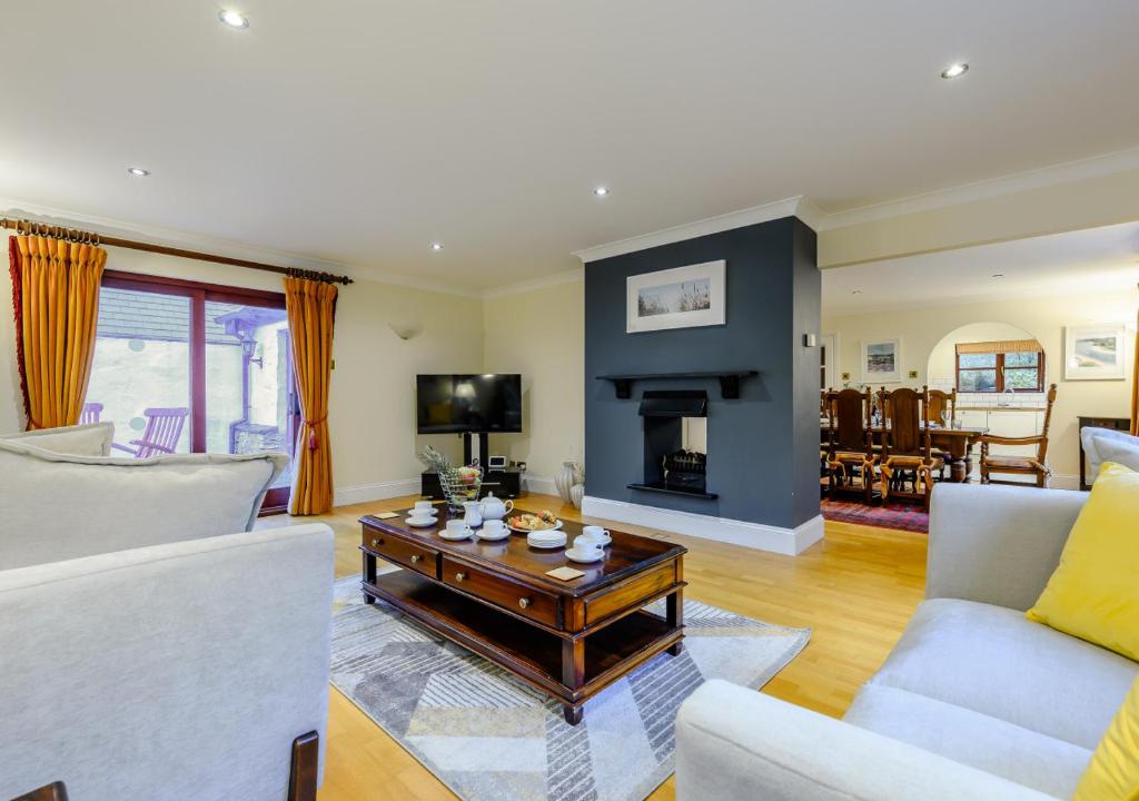 a living room with a couch and a table at Poppy Cottage - Cornwall in Saint Wenn