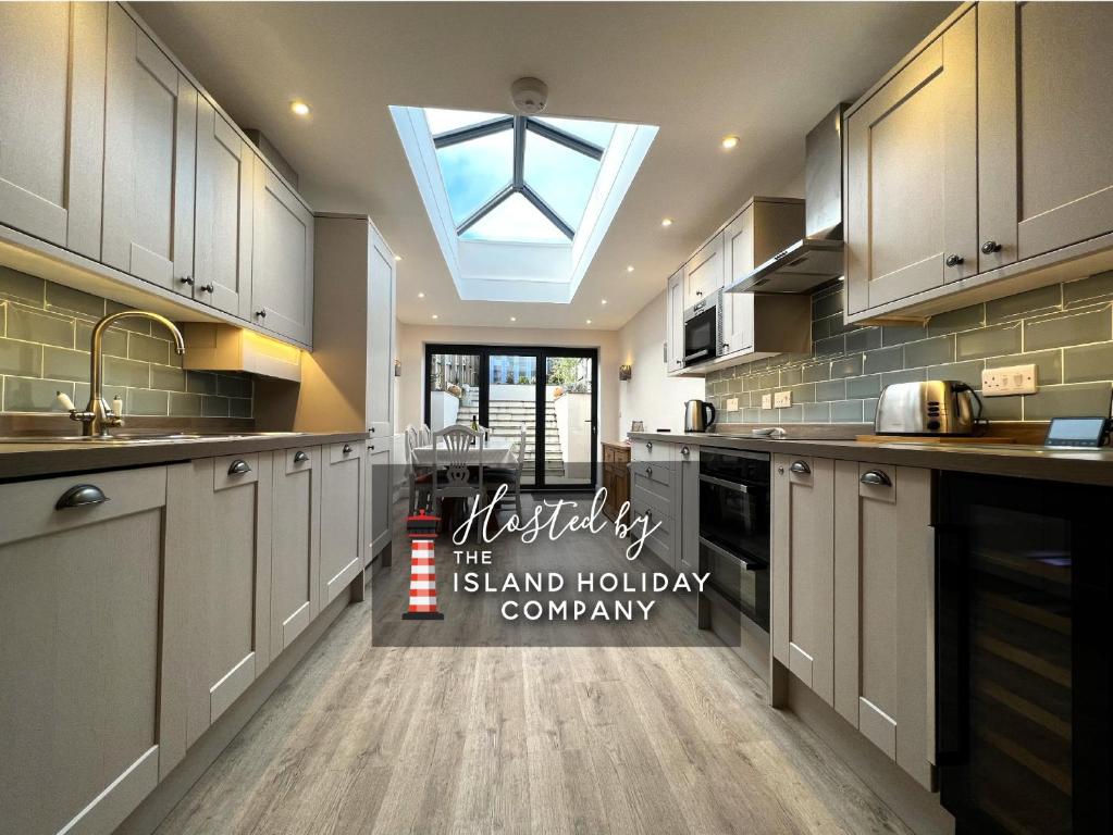 a kitchen with a skylight in the middle of it at York Street in Cowes