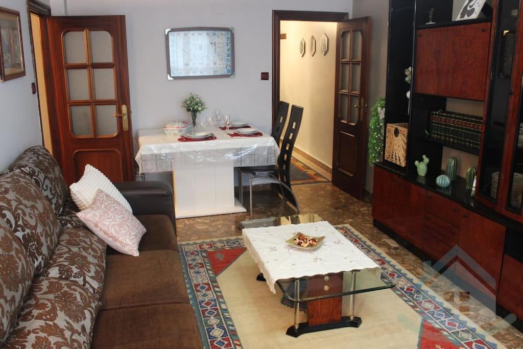 a living room with a couch and a table at Tranquilo apartamento en Pola de Siero in Siero