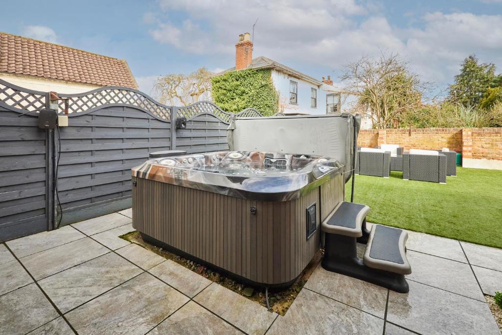 a hot tub in the backyard of a house at Host & Stay - Casa Feliz in Long Riston