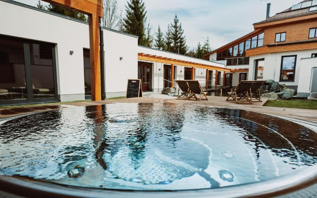 a swimming pool in the backyard of a house at Hotel Horal in Rožnov pod Radhoštěm