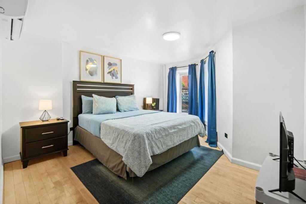 a bedroom with a bed and a tv in it at Renovated 3BR with Private Backyard in Bed-Stuy in Brooklyn