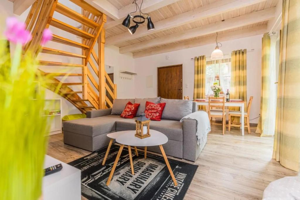 a living room with a couch and a table at Domek A 182 Leśne Zacisze- Kaszubska Ostoja in Barkocin