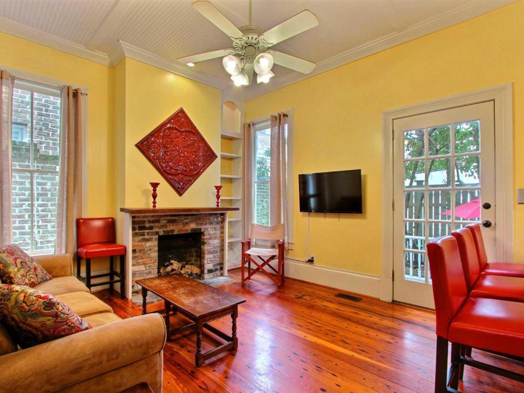 a living room with a fireplace and a tv at Washington Square Manor in Savannah