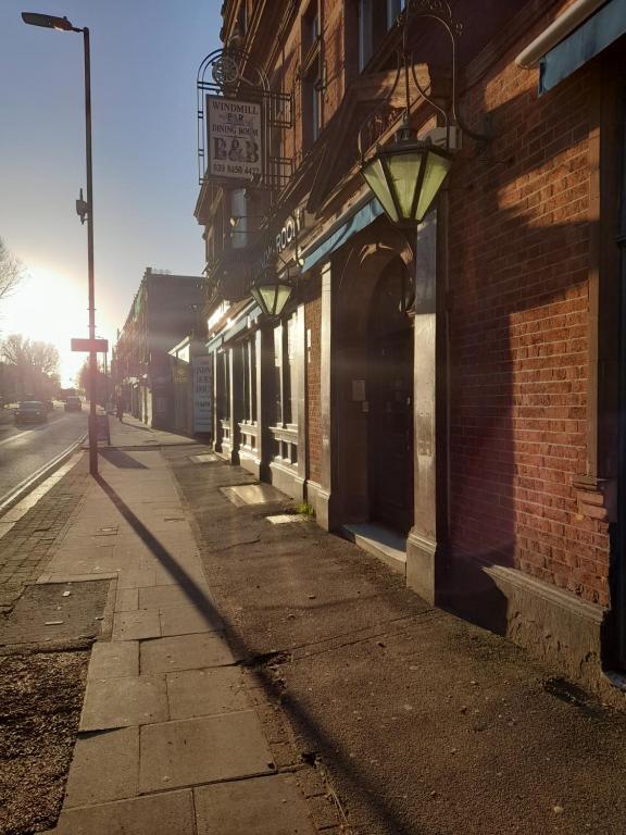 an empty street with a building and a street light at The Windmill Hotel in London
