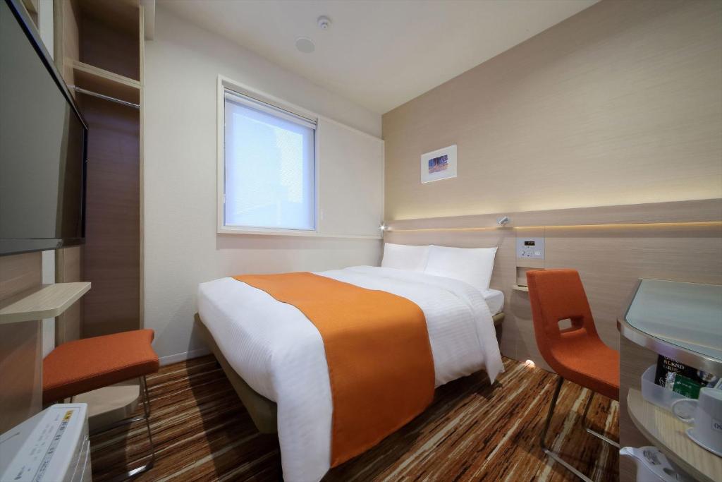 Postel nebo postele na pokoji v ubytování Keio Presso Inn Akasaka