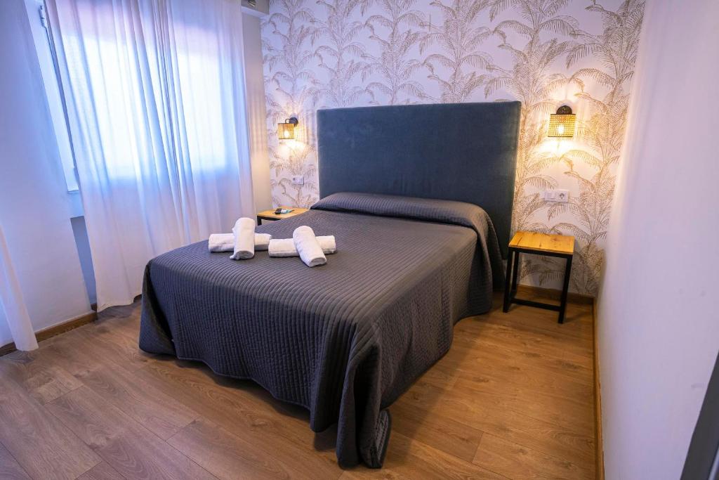 Un pat sau paturi într-o cameră la Complejo Roma