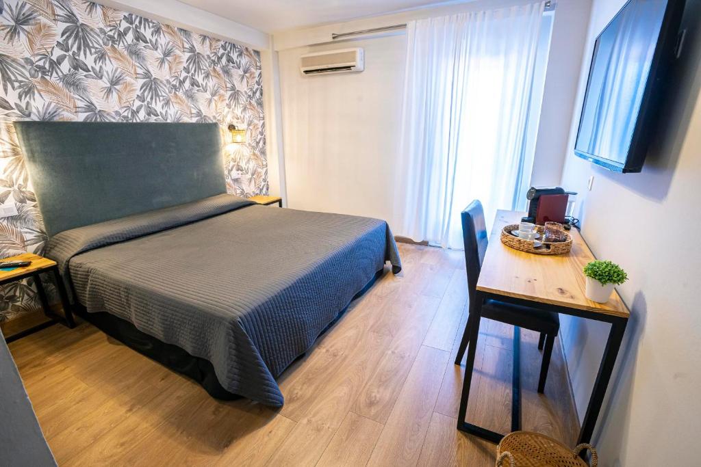 Postel nebo postele na pokoji v ubytování Complejo Roma