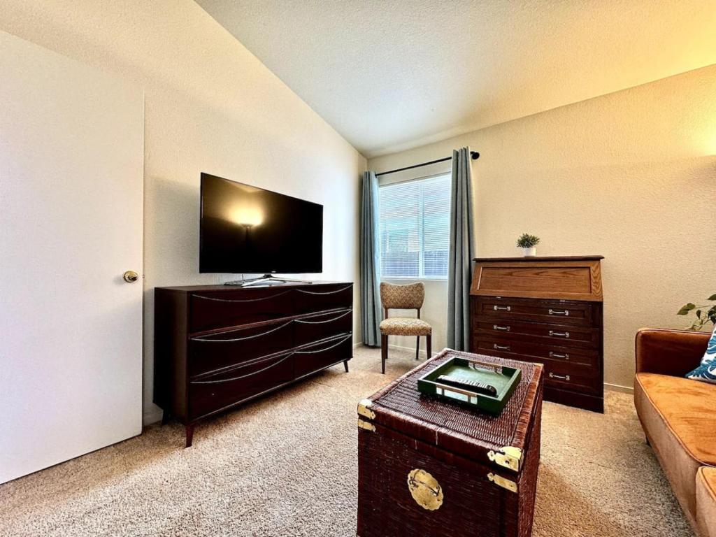 a living room with a flat screen tv and a couch at King Bed Retreat, Pet-Friendly, Rancho Cordova in Rancho Cordova