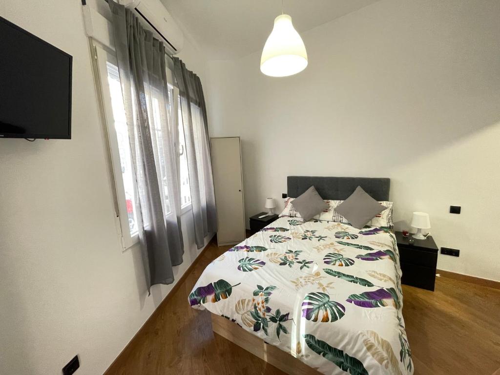 een slaapkamer met een bed met een dekbed erop bij HomeStay Lopez Pando in Madrid