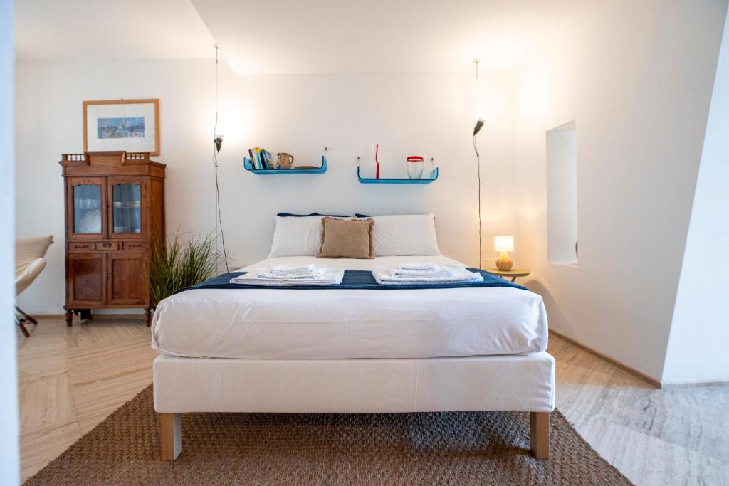 a bedroom with a large white bed in a room at La Casetta sul mare in Castellammare del Golfo