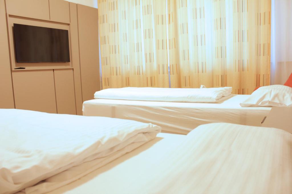 Postel nebo postele na pokoji v ubytování Isar City Hotel