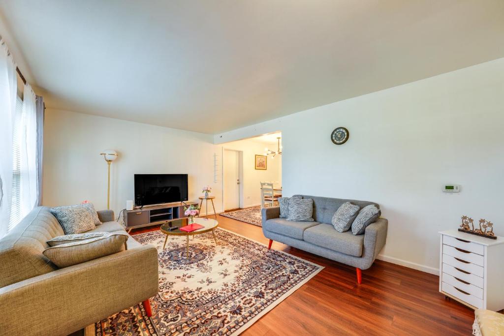 a living room with two couches and a tv at Cozy and Quiet Hanover Park Townhome! in Hanover Park