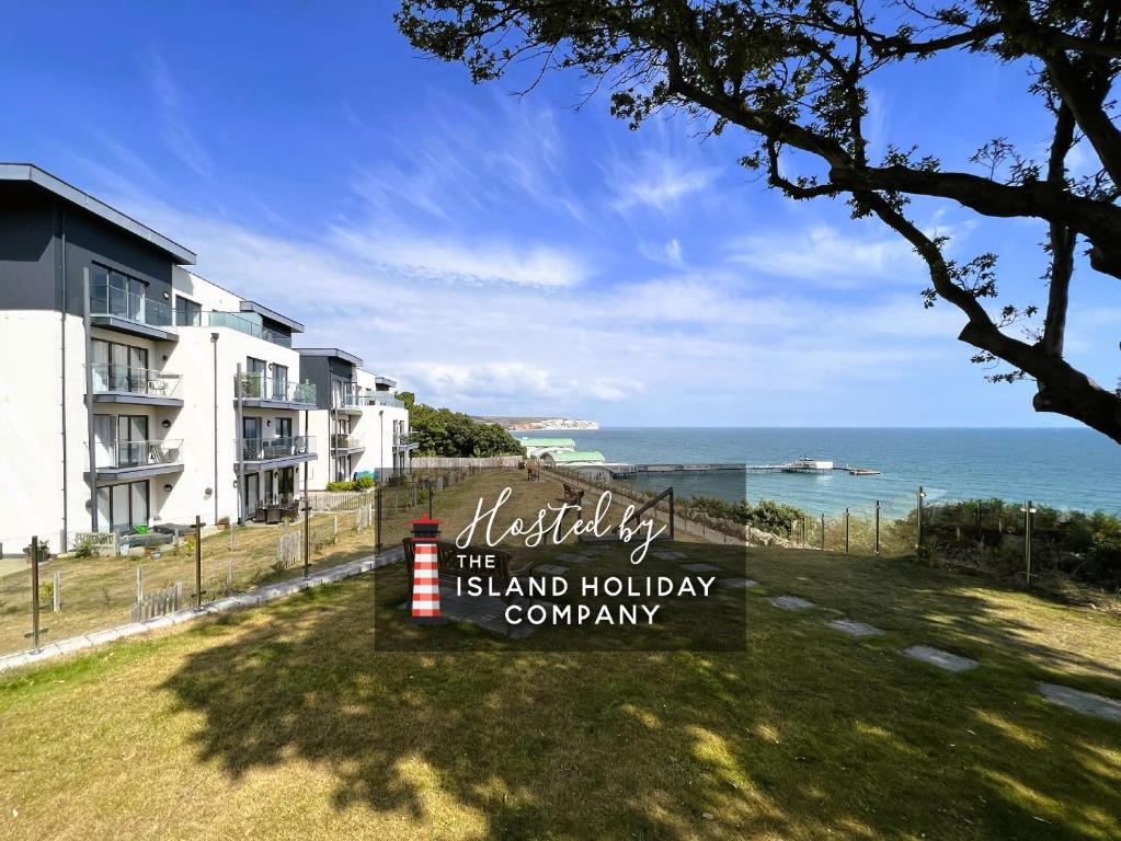 a view of the sand holiday company sign and the ocean at Sandy Shores in Sandown