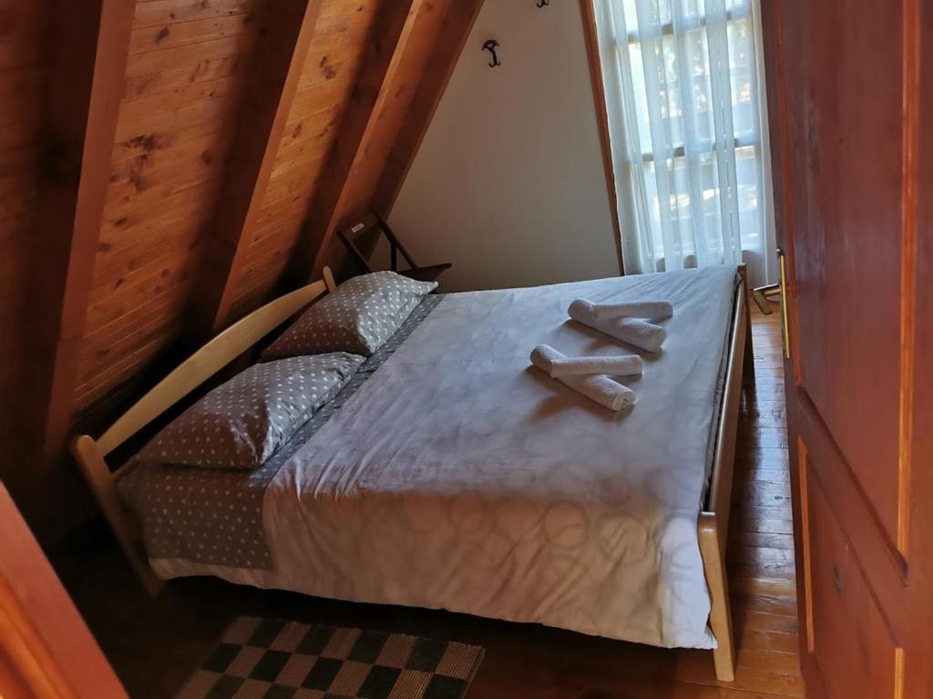 a bedroom with a bed with two towels on it at Blidinjehouse in Risovac