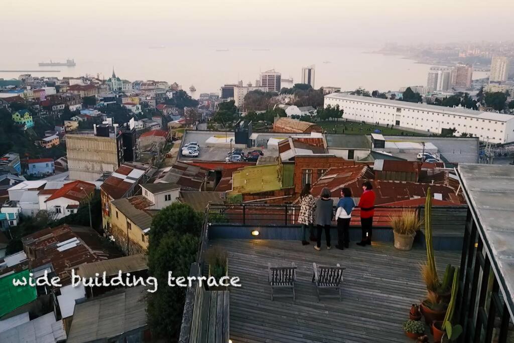 a group of people standing on the roof of a building at Patrimonial redesigned luminous loft for couples in Valparaíso