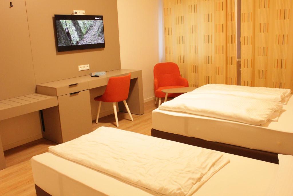 Postel nebo postele na pokoji v ubytování Isar City Hotel