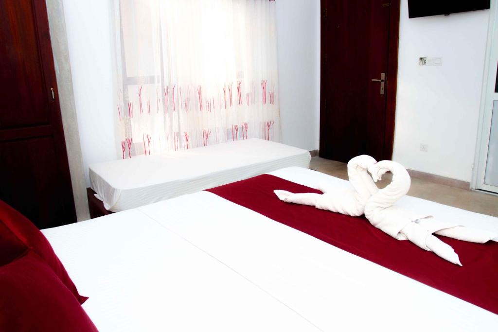 Postel nebo postele na pokoji v ubytování Mandavilla Airport Transit Hotel