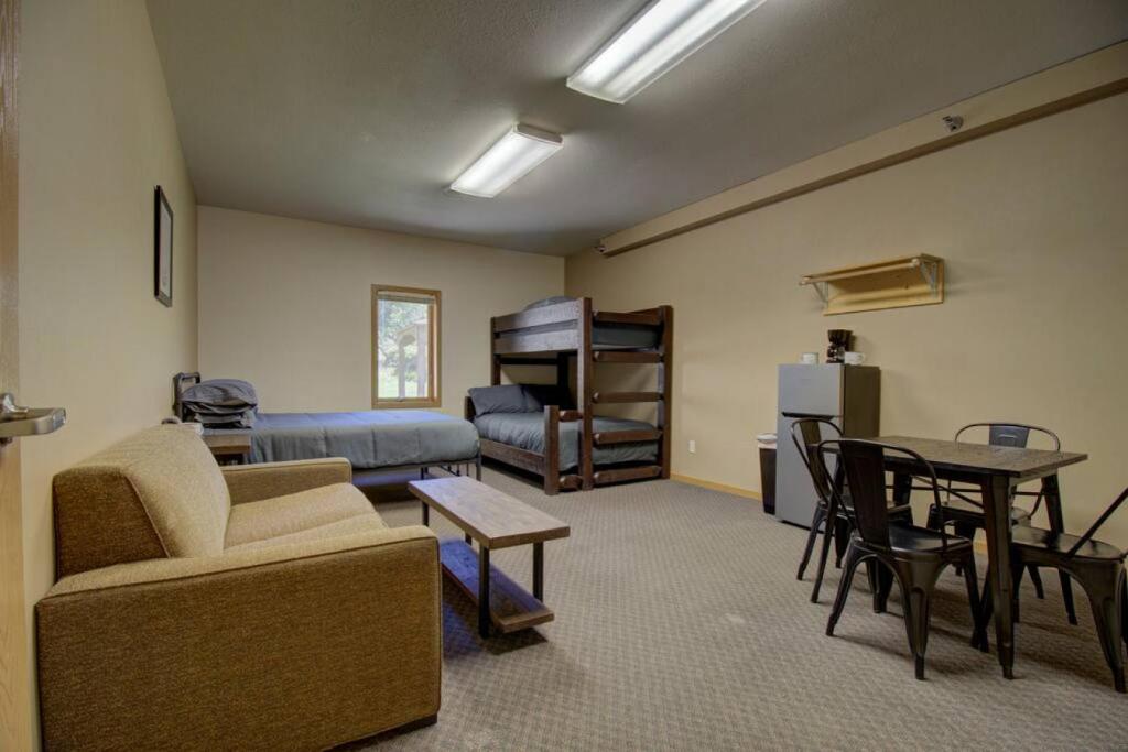 a living room with a couch and a bed and a table at Minnesota Lake Home Getaway Studio Style Room in Clitherall