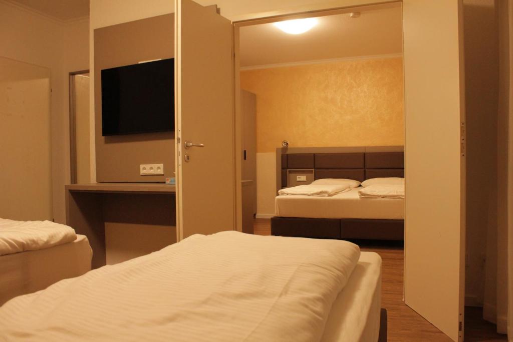 Postel nebo postele na pokoji v ubytování Isar City Hotel