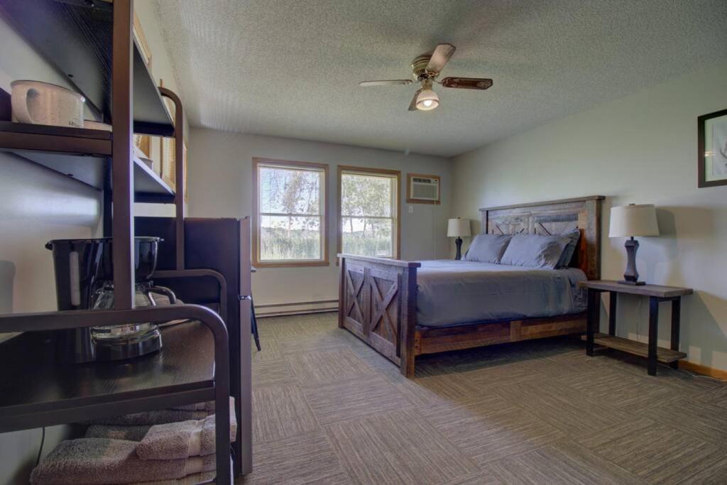 a bedroom with a bed with a ceiling fan at Spitzer Lake Escape to a Studio Style Cottage in Clitherall