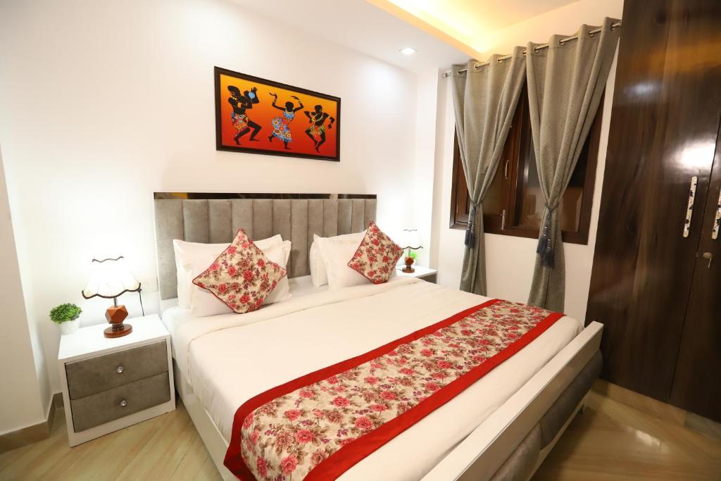 a bedroom with a large white bed with pillows at Hotel Ganga Ashoka - Rishikesh in Rishīkesh